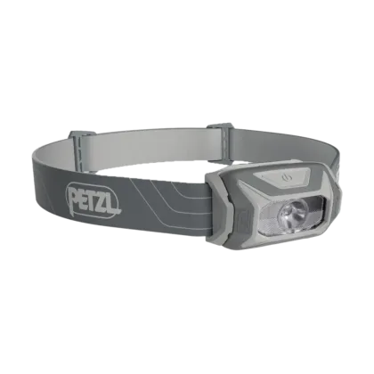 The PETZL TIKKINA® headlamp in Grey is a compact, user-friendly lighting solution designed for outdoor enthusiasts. Offering 300 lumens of brightness, it provides uniform and comfortable illumination suitable for a variety of activities, from reading in your tent to navigating around the campsite or on nighttime hikes. This headlamp is distinguished by its easy operation, adjustable symmetrical headband, and versatility, supporting both standard and CORE rechargeable batteries with its HYBRID CONCEPT design. Comes with LR03 batteries.