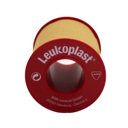 Leukoplast® Standard Rigid tan-coloured zinc oxide tape, 5cm x 5m, offers strong adhesion and high tensile strength, ideal for securing dressings and equipment on intact skin. It's water-repellent, breathable, and features antimicrobial components.