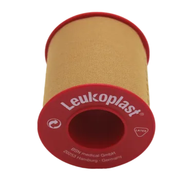 Leukoplast® Standard Rigid tan-coloured zinc oxide tape, 5cm x 5m, offers strong adhesion and high tensile strength, ideal for securing dressings and equipment on intact skin. It's water-repellent, breathable, and features antimicrobial components.