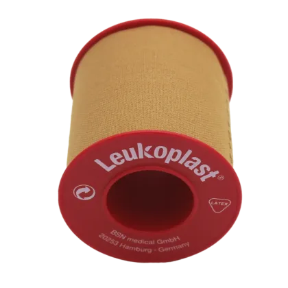 Leukoplast® Standard Rigid tan-coloured zinc oxide tape, 5cm x 5m, offers strong adhesion and high tensile strength, ideal for securing dressings and equipment on intact skin. It's water-repellent, breathable, and features antimicrobial components.