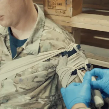 The NORSE RESCUE® Bandage Anchoring Device (B.A.D.) enhances trauma bandage stability, providing additional pressure and securing options, particularly in challenging areas. With its four-point anchoring system, it ensures secure placement during patient transport or movement, aiding in effective wound care for adults and children. For trained personnel only. - CL-100750