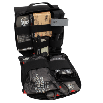 The NORSE RESCUE® Týr Bag in black is a durable and spacious personal medical bag designed for battlefield and emergency response use. Made from high-quality CORDURA® fabric with YKK zippers and a UTX safety buckle, it offers exceptional durability and secure storage. Featuring a tear-off panel for quick access, internal elastic webbing for organized storage, and ample space for essential trauma and emergency medical supplies, this bag ensures users are prepared for critical situations. - BA-100036