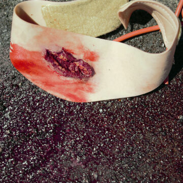 The Neck Wound is a wearable trauma simulator replicating a neck injury with exposed fat and muscle. Designed with integrated blood tubing and realistic materials, it wraps securely around an actor or manikin for effective bleeding control training. - SÅR-WW3-014